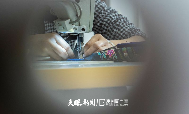 732248-2024年4月9日，貴州省黔西南州望謨縣一家民族服飾加工生產(chǎn)車間內(nèi)，工人在縫制傳統(tǒng)布依族服飾。.jpg